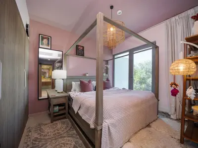 a bedroom with a canopy bed and a mirror at Family Friendly Villa in Tilal Al Ghaf with Garden and Padel Courts Pet Friendly in Dubai