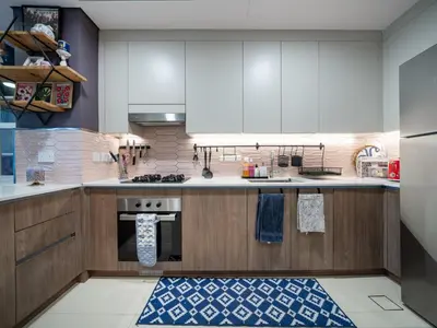 a kitchen with white cabinets and a blue and white rug at Family Friendly Villa in Tilal Al Ghaf with Garden and Padel Courts Pet Friendly in Dubai