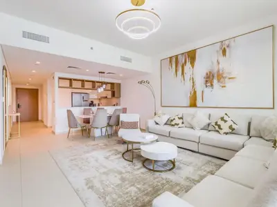 a living room with a white couch and a table at TRPS - Downtown Views II Tower 2, Downtown Dubai - 3BR plus Maids - Burj Khalifa View - Walk to Dubai Mall in Dubai