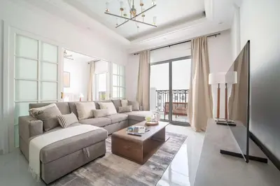 a living room with a couch and a table at Frank Porter - Vincitore Benessere 2 in Dubai