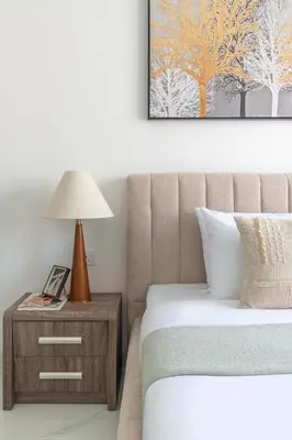a bedroom with a bed and a table with a lamp at Frank Porter - Vincitore Benessere 2 in Dubai