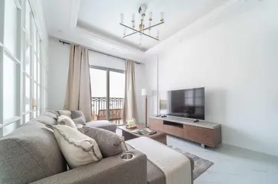 a living room with a couch and a flat screen tv at Frank Porter - Vincitore Benessere 2 in Dubai