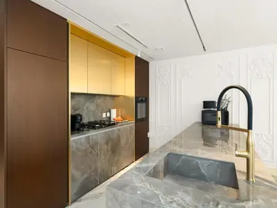 a kitchen with a marble counter top and a sink at Elie Saab Collection by Luxe Manor - Dubai Mall Residences in Dubai