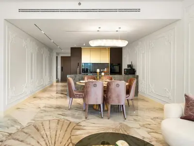 a dining room with a table and chairs at Elie Saab Collection by Luxe Manor - Dubai Mall Residences in Dubai