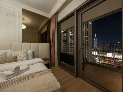 a bedroom with a large window with a view of the city at Elie Saab Collection by Luxe Manor - Dubai Mall Residences in Dubai