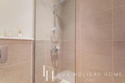 a shower in a bathroom with the words lux holiday home at LUX Dubai Hills Sway Studio in Dubai