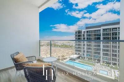 a balcony with a view of a pool and a building at LUX Dubai Hills Sway Studio in Dubai