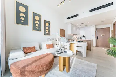 a living room with a couch and a table at Newly Furnished Apartment near Circle Mall with Marina Views, Binghatti Onyx, JVC by Deluxe Holiday Homes in Dubai