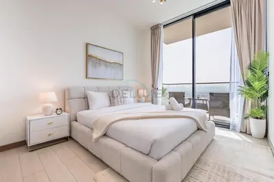 a bedroom with a large bed and a couch at Newly Furnished Apartment near Circle Mall with Marina Views, Binghatti Onyx, JVC by Deluxe Holiday Homes in Dubai