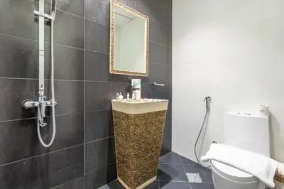 a bathroom with a sink and a toilet and a mirror at Studio Near Dubai Butterfly Garden, 18 Mins Drive From Mall of Emirates, Miraclz Tower, Arjan By Deluxe Holiday Homes in Dubai