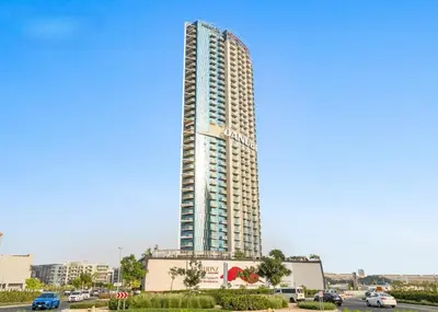 a tall building with a sign on the side of it at Studio Near Dubai Butterfly Garden, 18 Mins Drive From Mall of Emirates, Miraclz Tower, Arjan By Deluxe Holiday Homes in Dubai