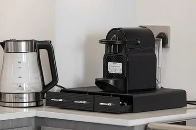 a coffee pot sitting on top of a counter at Sky-High Luxury 2BR Burj View Walk Dubai Mall in Dubai