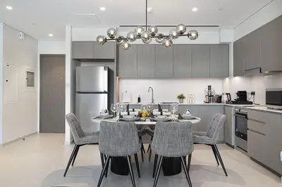 a kitchen with a table and chairs in a kitchen at Sky-High Luxury 2BR Burj View Walk Dubai Mall in Dubai