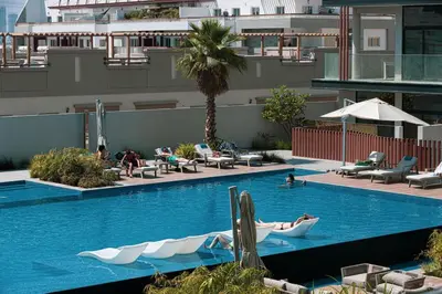 a swimming pool with boats in the middle of a building at Restay Homes - Chic Studio in JVC - Pool Views in Dubai
