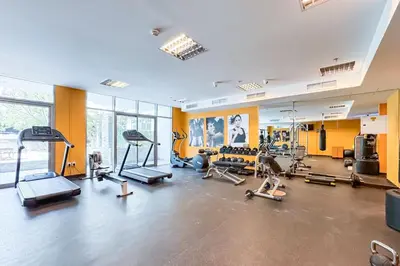 a gym with several treadmills and exercise machines at Luxury JVC 2 Bed Duplex with Private Pool and Jacuzzi in Dubai