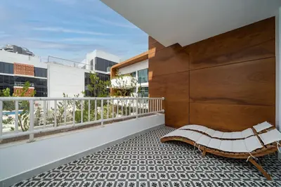 a balcony with a bench on top of a building at Luxury JVC 2 Bed Duplex with Private Pool and Jacuzzi in Dubai