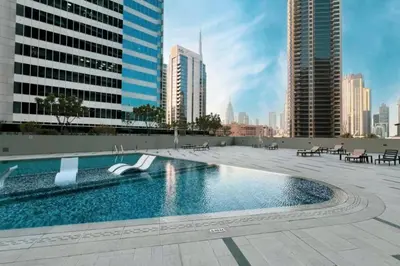 a swimming pool on top of a building with tall buildings at Elegant Cozy Studio Canal View in Dubai