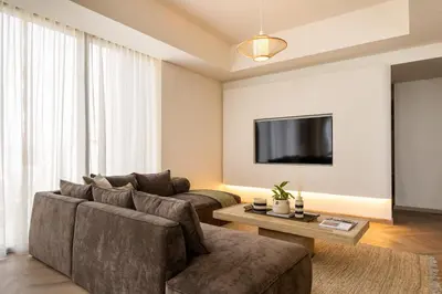 a living room with a couch and a tv at Seraya Residences at 52-42 EMAAR in Dubai