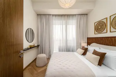 a bedroom with a large white bed and a window at Seraya Residences at 52-42 EMAAR in Dubai