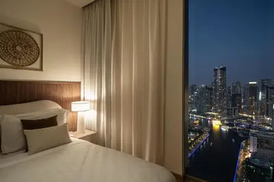 a bedroom with a window with a view of a city at Seraya Residences at 52-42 EMAAR in Dubai