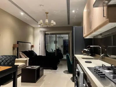 a kitchen and a living room with a couch at Luxury Downtown Studio - Elite Downtown Residence 1 - Burj Khalifa View Balcony in Dubai