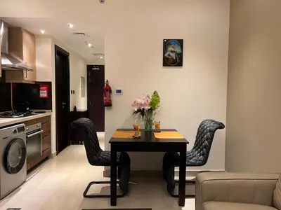 a kitchen with a table and chairs in a room at Luxury Downtown Studio - Elite Downtown Residence 1 - Burj Khalifa View Balcony in Dubai