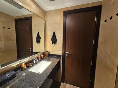 a bathroom with a sink and a large mirror at Luxury Downtown Studio - Elite Downtown Residence 1 - Burj Khalifa View Balcony in Dubai