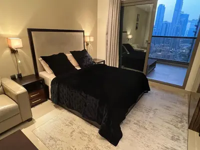 a bedroom with a large bed and a view of a city at Luxury Downtown Studio - Elite Downtown Residence 1 - Burj Khalifa View Balcony in Dubai