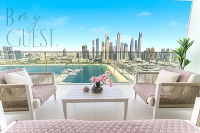 a living room with a view of the city at Peerless 3BR Beachfront Living in Sunrise Bay in Dubai