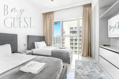 a hotel room with two beds and a window at Peerless 3BR Beachfront Living in Sunrise Bay in Dubai