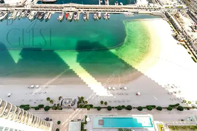 an aerial view of a beach and the ocean at Peerless 3BR Beachfront Living in Sunrise Bay in Dubai