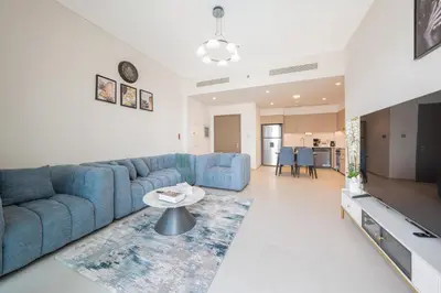 a living room with a blue couch and a table at The Skyline Burj Retreat in Dubai