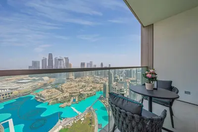 a balcony with a table and chairs and a view of a city at The Skyline Burj Retreat in Dubai