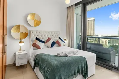 a bedroom with a bed and a large window at Burj Vista - Prime Downtown Dubai in Dubai