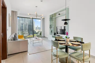 a dining room and living room with a table and chairs at Burj Vista - Prime Downtown Dubai in Dubai