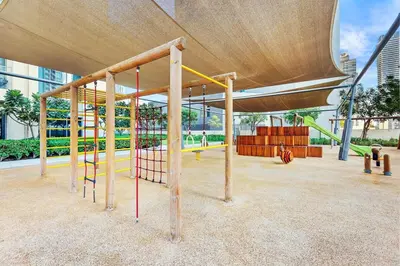 a park with a playground with a slide at Elegant 1BR Near Burj Khalifa and Dubai Mall with Pool, Balcony, & Gym in Dubai