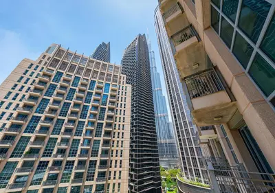a group of tall buildings in a city at Stunning 1 BR Apartment Walk to Burj Khalifa & Dubai mall in Dubai