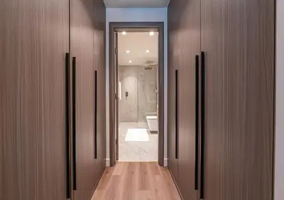a corridor of a bathroom with a shower and a toilet at Stunning 1 BR Apartment Walk to Burj Khalifa & Dubai mall in Dubai