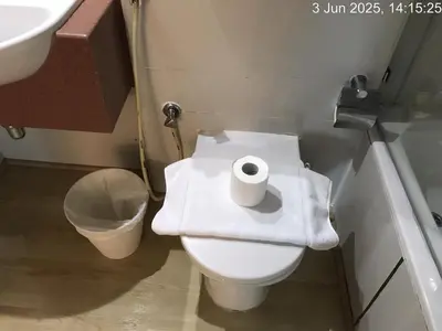 a bathroom with a toilet with a roll of toilet paper on it at Cozy 1 Bed aprt in Marina Diamond 1 Tower in Dubai
