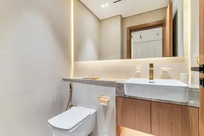 a bathroom with a white toilet and a sink at DAYF-AMB Brand New Cozy 1 Bed up to 4 Guests in Dubai