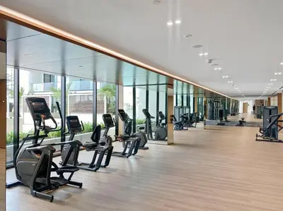 a gym with treadmills and ellipticals in a building at DAYF-AMB Brand New Cozy 1 Bed up to 4 Guests in Dubai
