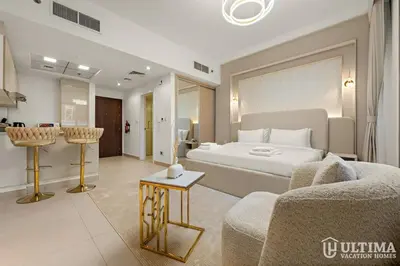 a hotel room with a bed and a couch at Lovely Studio in JVC with Summer Offer in Dubai