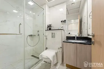 a bathroom with a shower and a toilet and a sink at Lovely Studio in JVC with Summer Offer in Dubai