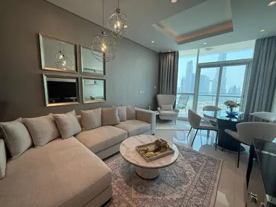 a living room with a couch and a table at Full BurjKhalifa View - Luxury 2BR in 5Stars Hotel in Dubai