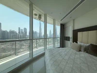 a bedroom with a large bed and large windows at Full BurjKhalifa View - Luxury 2BR in 5Stars Hotel in Dubai