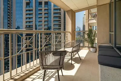 a balcony with two chairs and some buildings at GuestReady - Delightful haven near Burj Khalifa in Dubai