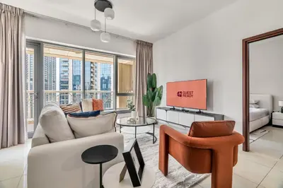 a living room with a couch and a chair at GuestReady - Delightful haven near Burj Khalifa in Dubai
