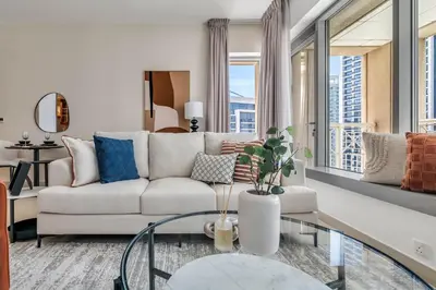a living room with a white couch and a glass table at GuestReady - Delightful haven near Burj Khalifa in Dubai