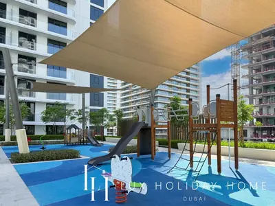 a playground with a slide and a swing set at LUX The Palace Beach Suite in Dubai