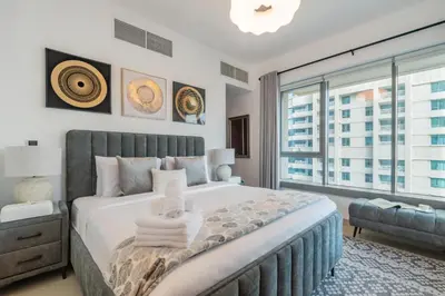 a bedroom with a large bed and a large window at 29 Boulevard Tower 1 Apartment by GLOBALSTAY in Dubai